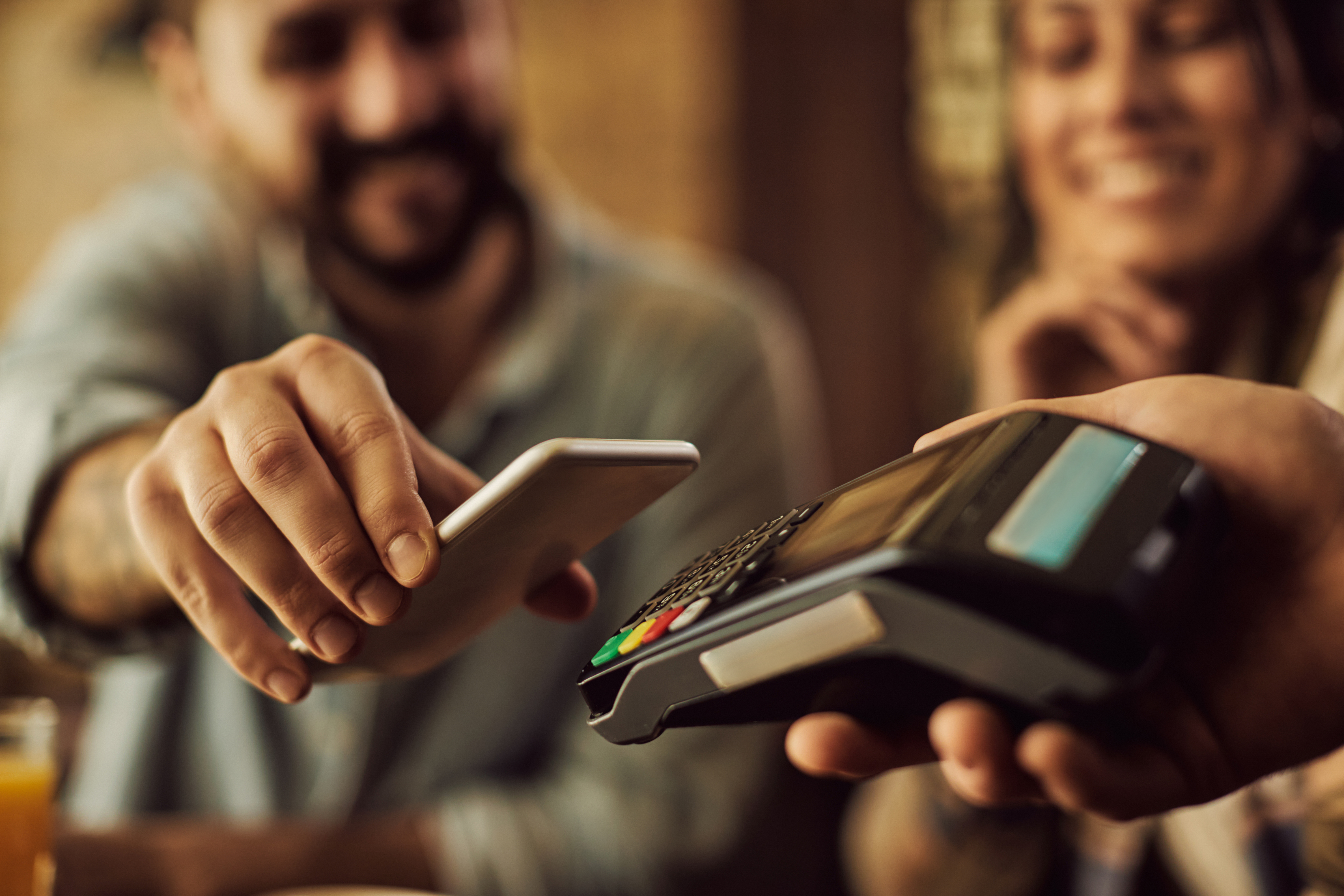 closeup-man-making-contactless-payment-with-smart-phone.jpg