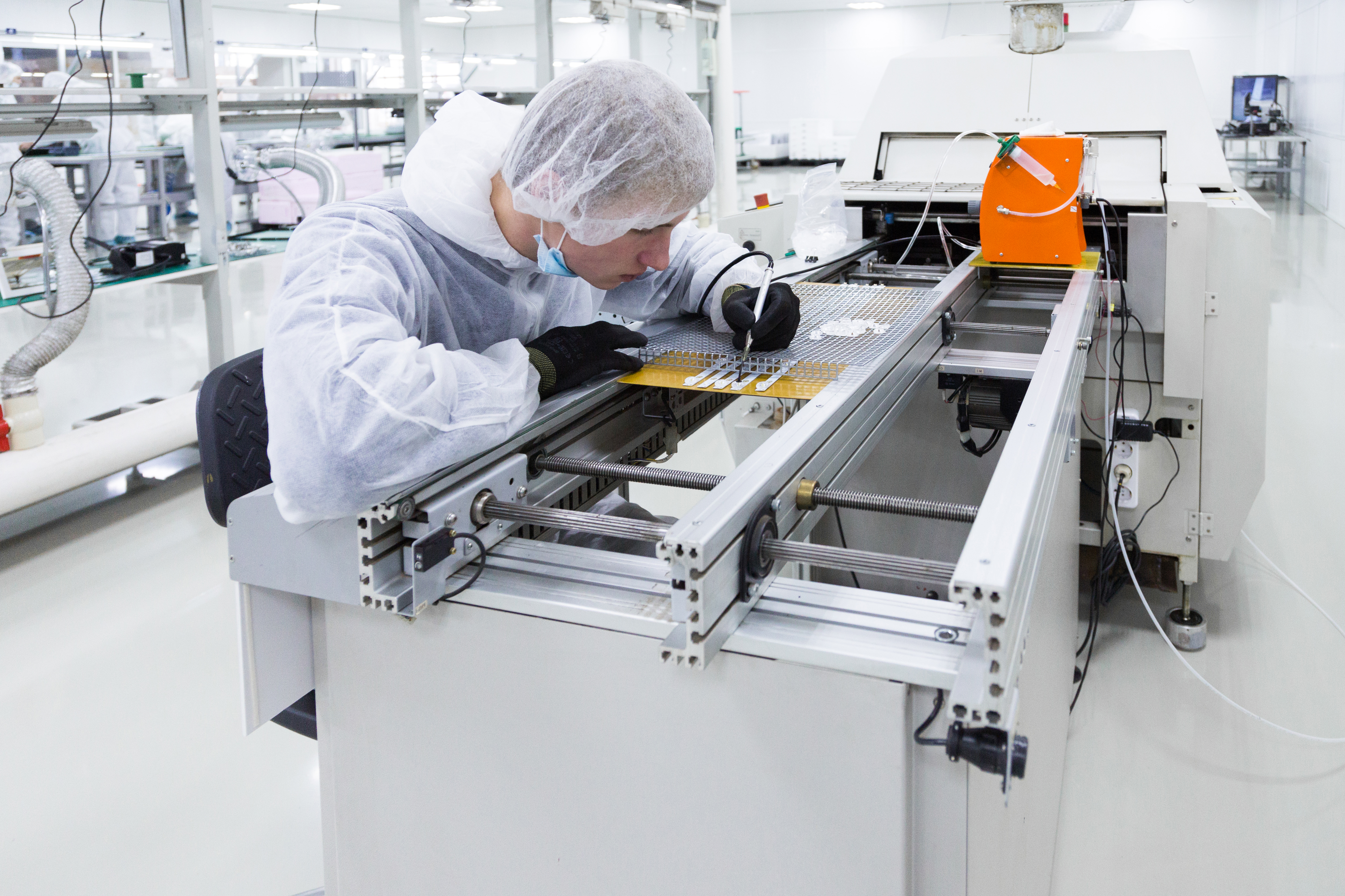 factory-worker-white-lab-suit-latex-gloves-working-with-soldering-iron-some-modern-equioment.jpg